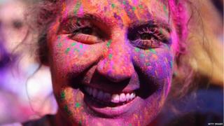 A competitor covered in coloured powder poses after finishing the Color Run at Sydney Olympic Park on February 9, 2014 in Sydney, Australia. (Photo by Mark Kolbe/Getty Images)
