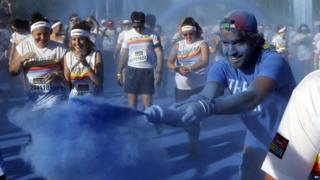 Runners being pelted with blue paint