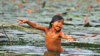 A girl in a pond with flowers