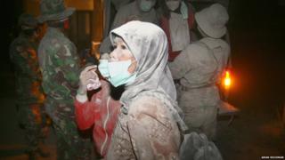 People covered in ash