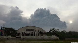 Ash clouds seen over the roof of a building