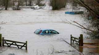 A car sits in flood water