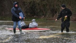 People use canoes to transport their belongings