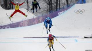 Skiers jumping