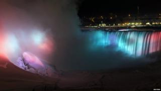 A partially frozen base of Horseshoe Falls is seen on lit by lights during sub freezing temperatures in Niagara Falls, Ontario