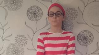 Ella dressed in red and white striped costume