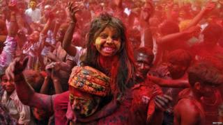 A girl covered in red paint