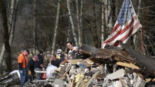 Volunteers moving rubble in Oso following landslide.