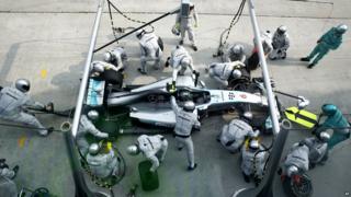 The pit crew for Mercedes driver Nico Rosberg of Germany change his tires.