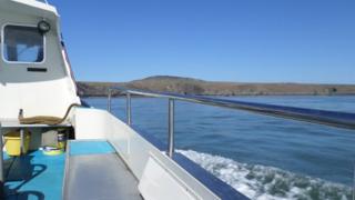 Boat on the water looking over board to Ramsey Island