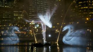 Ballet dancer and swans from Swan Lake is projected onto spraying water by the Vivid Aquatique Water Theatre.