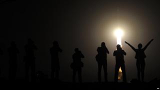People watch as the Soyuz TMA-13M spacecraft makes it's way into orbit