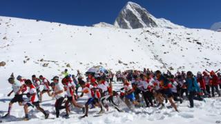 Runners start off on their 26.2 mile run down Mount Everest.