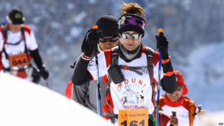 A female runner makes her way up a steep part of the course.