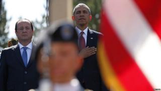 President Barack Obama (C) and French President Francois Hollande (L) participate in the 70th French-American Commemoration D-Day Ceremony at the Normandy American Cemetery and Memorial in Colleville-sur-Mer June 6, 2014. World leaders and veterans gathered by the beaches of