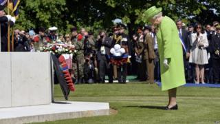 Britain"s Queen Elizabeth lays a wreath during a bi-national France-UK D-Day commemoration ceremony at the British War Cemetery of Bayeux on June 6,