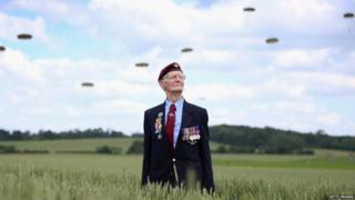 Fred Glover, aged 88, a veteran of the 9th Para Battalian watches a parachute jump just outside Rainville during D-Day 70 Commemorations on June 5, 2014 in Ranville, France.