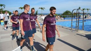 England players walk by hotel pool