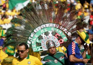 A man with an enormous feathery headdress