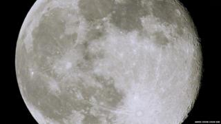 The moon fills the photograph. Craters and details on the surface of the moon can be seen.