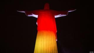 Christ the Redeemer is illuminated in the colours of Germany's national flag