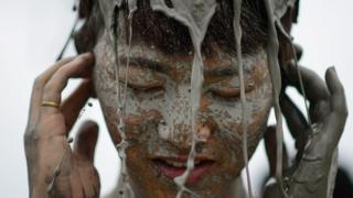Woman covered in mud
