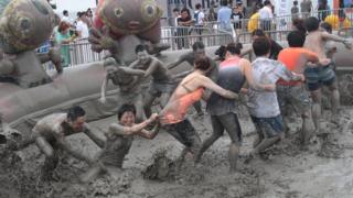 People in mud pit