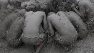 People covered in mud