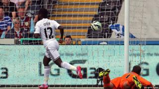 Swansea City's English midfielder Nathan Dyer (L) scores the opening goal during the English Premier League football match between Swansea City and Burnley at the Liberty Stadium in Swansea