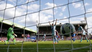 West Ham United's Carlton Cole (C, back) scores a goal against Crystal Palace during their English Premier League soccer match at Selhurst Park in London