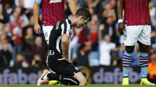 Newcastle United's Mike Williamson reacts after being sent off during their English Premier League soccer match against Aston Villa at Villa Park in Birmingham