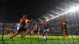 Hull defender Curtis Davies diverts the ball into his own net for the second West Ham goal during the Barclays Premier League match between Hull City and West Ham United at KC Stadium