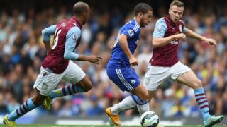 Chelsea’s Eden Hazard competes for the ball with Aston Villa’s Fabian Delph and Aston Villa’s Tom Cleverley during their English Premier League soccer match against Aston Villa at Stamford Bridge