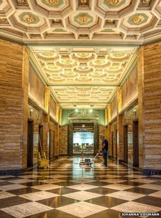 A man polishes the floor of a building