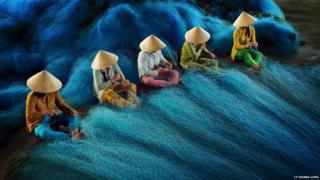 People mend nets
