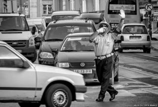 Traffic warden dancing in the street in Lisbon