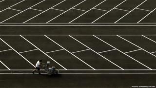 A man paints white lines