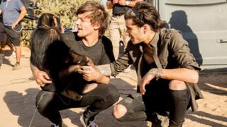 Louis and Zain hug the chimp