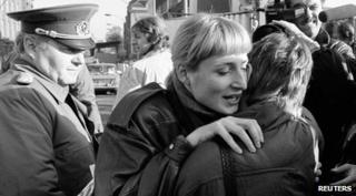 People embracing after Berlin Wall falls