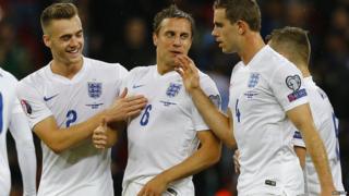 Phil Jagielka celebrates with teammates Callum Chambers and Jordan Henderson