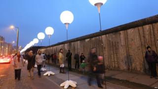 Row of illuminated balloons through Berlin