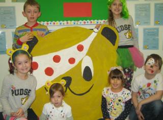 Children with a Pudsey bear face