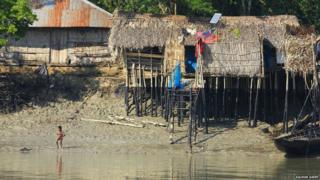 Oil-covered houses by the river