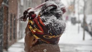 Woman with a head covered in snow