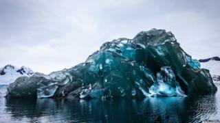 a photograph of an upside down iceberg.