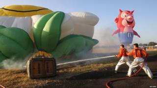 Firefighters tackle a burning hot air balloon