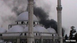 A handout image released by the Syrian opposition's Shaam News Network on June 16, 2012 allegedly shows smoke rising from a mosque following shelling by government forces on the Khalidiyeh neighbourhood of the restive central city of Homs