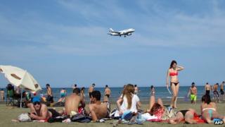 Locals and holiday makers sunbathe on southern coast of Cyprus on June 3 2012