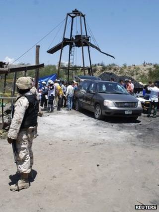 A soldier stands guard near a coal mine after an explosion in Muzquiz
