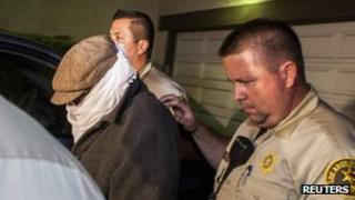Nakoula Basseley Nakoula with hat, scarf and glasses on being escorted from his home